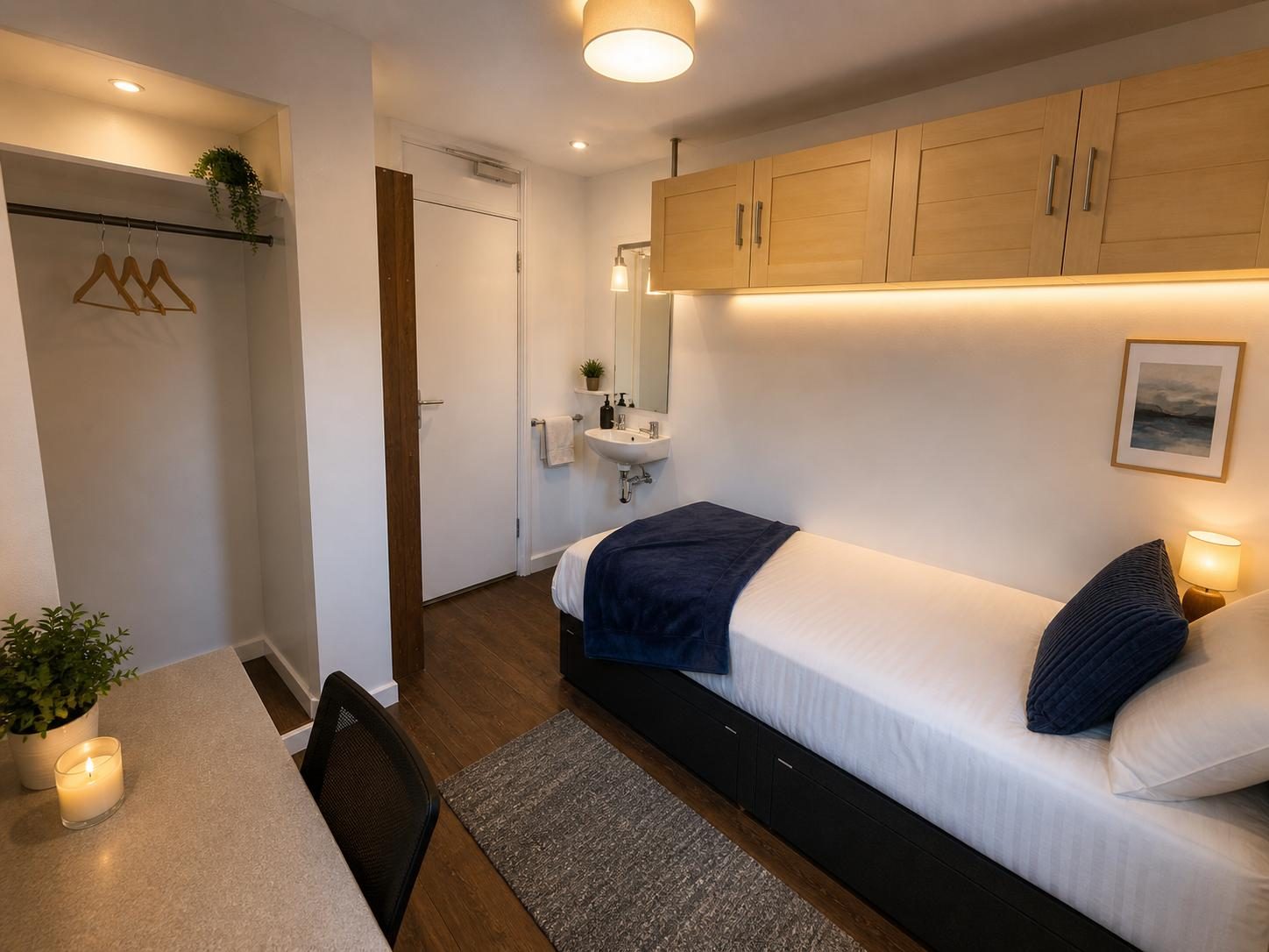 Finished bedroom with fitted storage, desk and ambient lighting